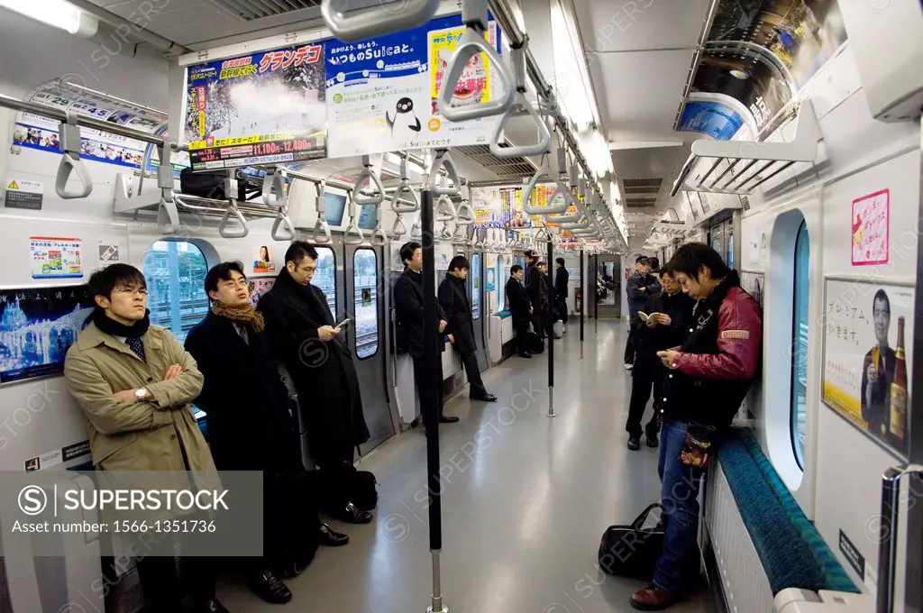 JAPAN, TOKYO, TRANSPORTATION SYSTEM, PEOPLE ON TRAIN.