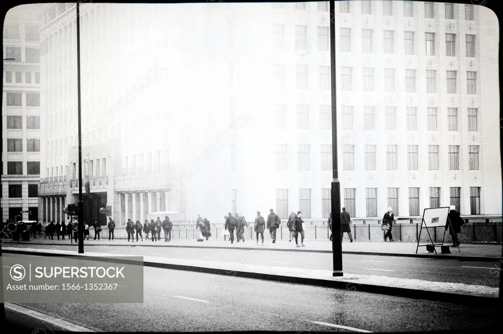 People walking on the way to work in London Bridge, City of London, England