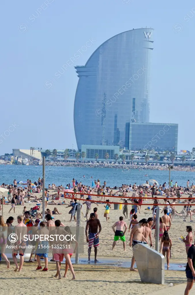 Summer. People at the beach. Barceloneta beach and Hotel Vela by Ricard Bofill. Barcelona, Catalonia, Spain.