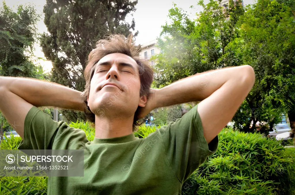 Man relaxing in public garden.