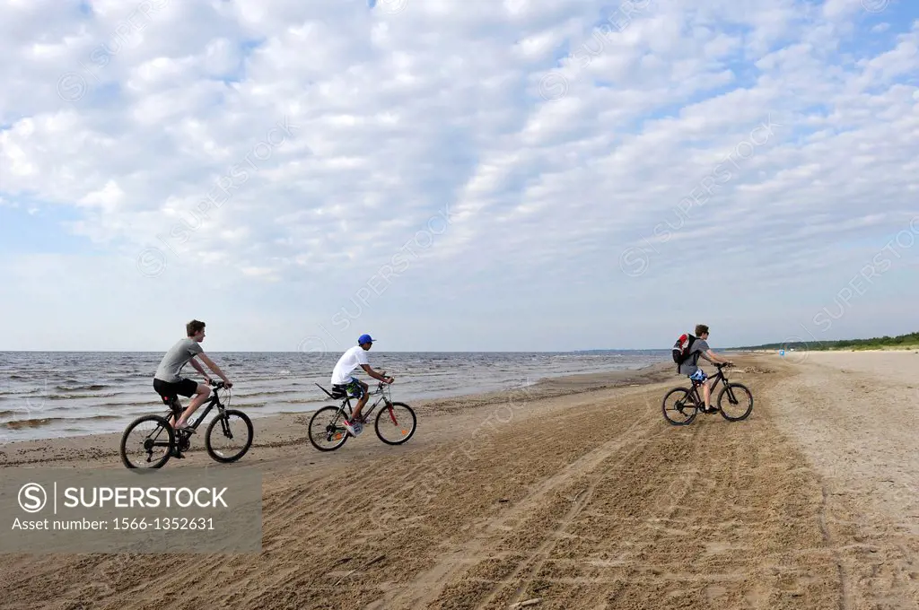 cyclist on a beach at Jurmala, Gulf of Riga, Latvia, Baltic region, Northern Europe.