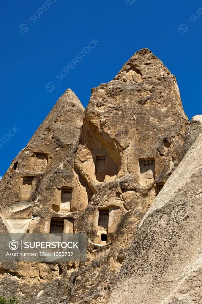 Hollowed fortress-like tuff rocks with storage rooms at the UNESCO World Heritage site Gí¶reme National Park and the Rock Sites of Cappadocia, Cavusin...