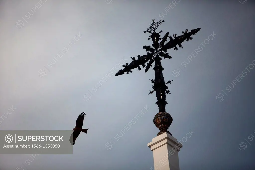 An eagle flies near the cross of the Hermitage of the Virgin of Rocio, in Almonte, Donana National Park, Huelva province, Andalusia, Spain, May 15, 20...