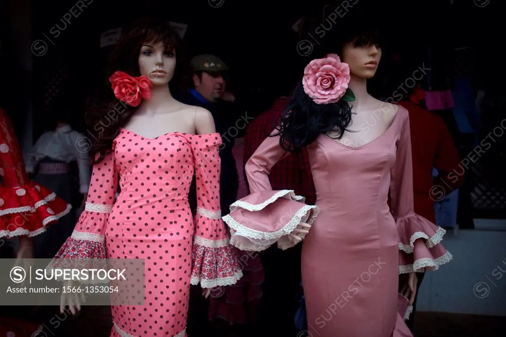 Female mannequin traditional Flamenco dresses sit for sale near the shrine of the Virgin of Rocio, in Almonte, Donana National Park, Huelva province, ...