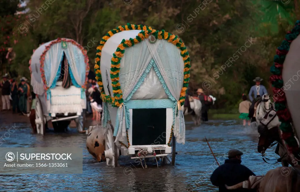 Riders and oxcarts of the Triana Brotherhood cross the Guadiamar´s river ford, known as Vado del Quema, during the pilgrimage to the shrine of the Vir...