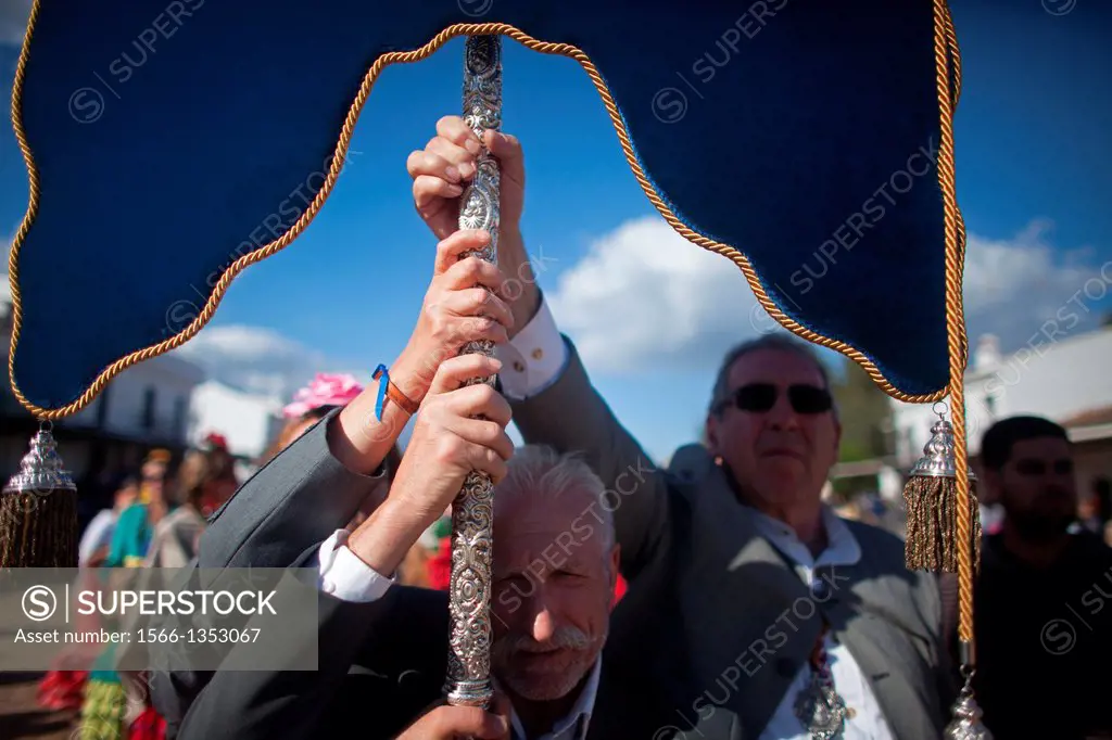 Senior men hold a banner against the wind during the pilgrimage to the shrine of the Virgin of Rocio, in Almonte, Donana National Park, Huelva provinc...
