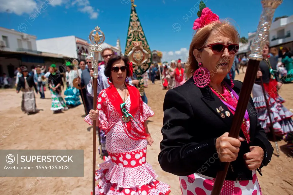 Female pilgrims holding staffs during the pilgrimage to the shrine of the Virgin of Rocio, in Almonte, Donana National Park, Huelva province, Andalusi...