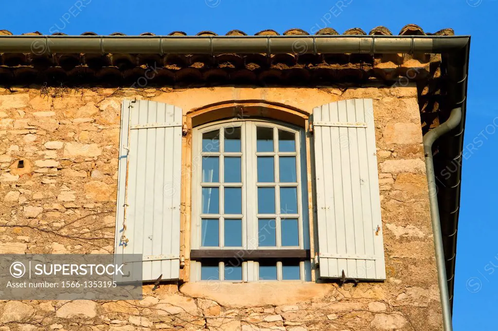Detail of a typical facade with window in Roque-sur-Ceze, labelled The Most Beautiful Villages of France. Gard deparment, Languedoc-Roussillon region....