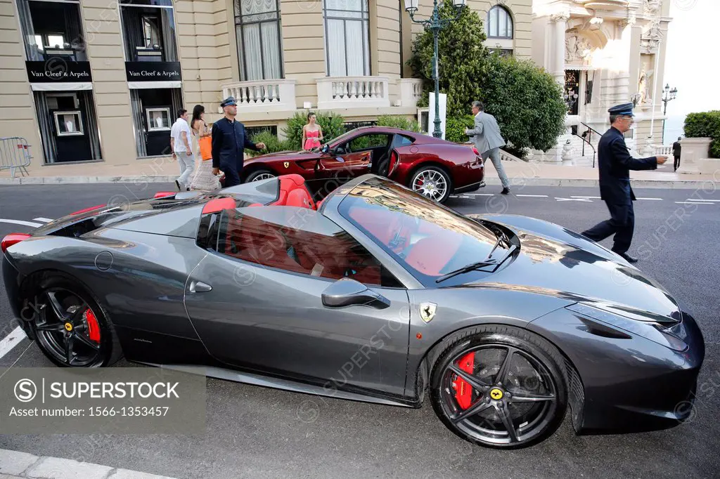 Europe, Principality of Monaco, tourists looking at luxury cars dropped by rich people at Casino or Hotel De Paris valet portiers, all properties of S...