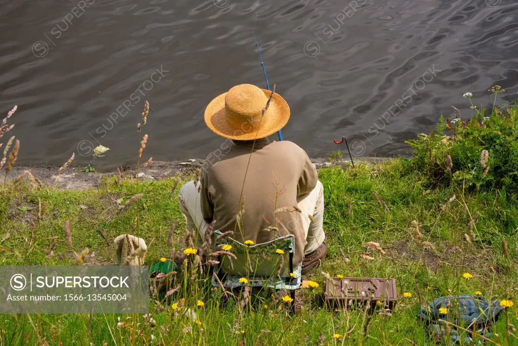 Fisherman fishing in the Loire river, with a beautiful hat, Nantes, Loire Atlantique, France
