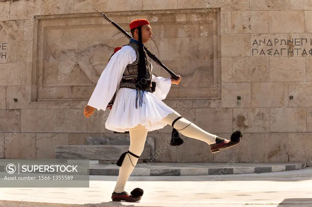 Greek soldier, Evzone, marching beside Tomb of the Unknown Soldier, outside Parliament building, Athens, Greece.