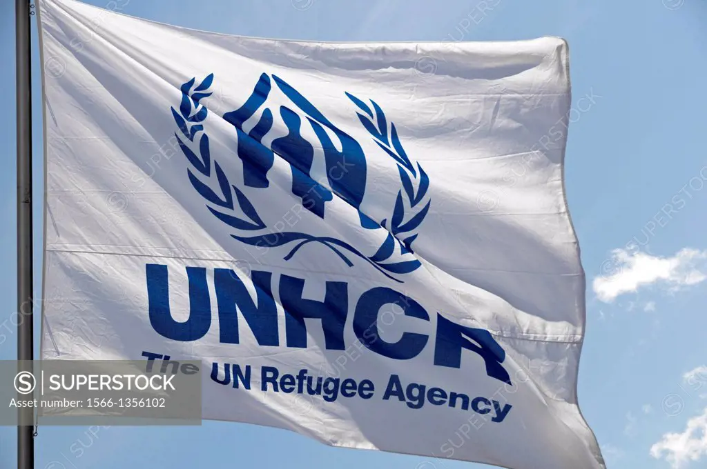 Flag of UNHCR - United Nations High Commissioner for Refugees, waving in front of UNHCR headquarters office in Geneva, Switzerland