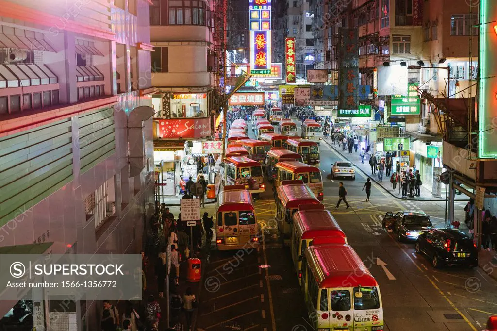 Mini Buses queue in gridlock traffic in Mongkok, Hong Kong at night.