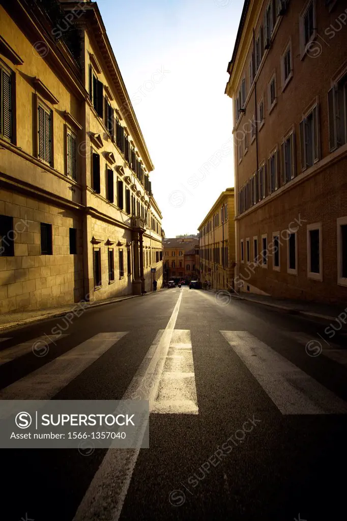 Sunrise on a street without people in the city of Rome, Italy.