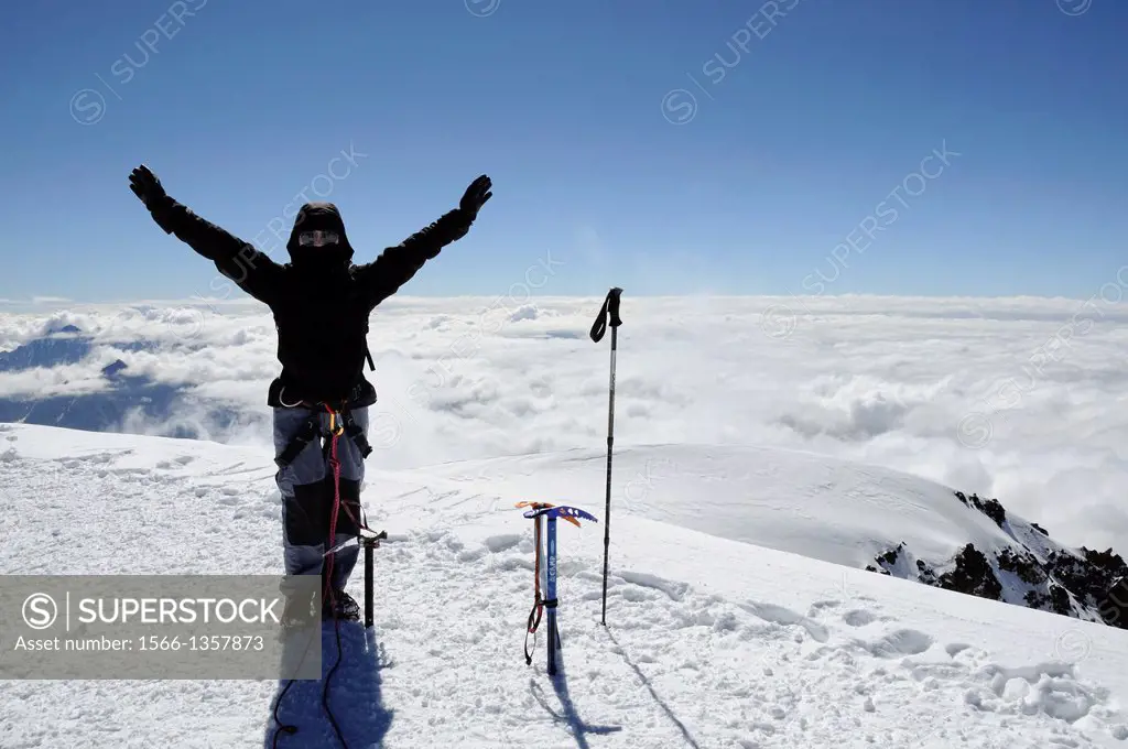 Happy mountaineer on the summit of Mount Kazbek, 5047m. Georgia, Greater Caucasus, Mtskheta-Mtianeti, Mount Kazbek. Model Released.1015