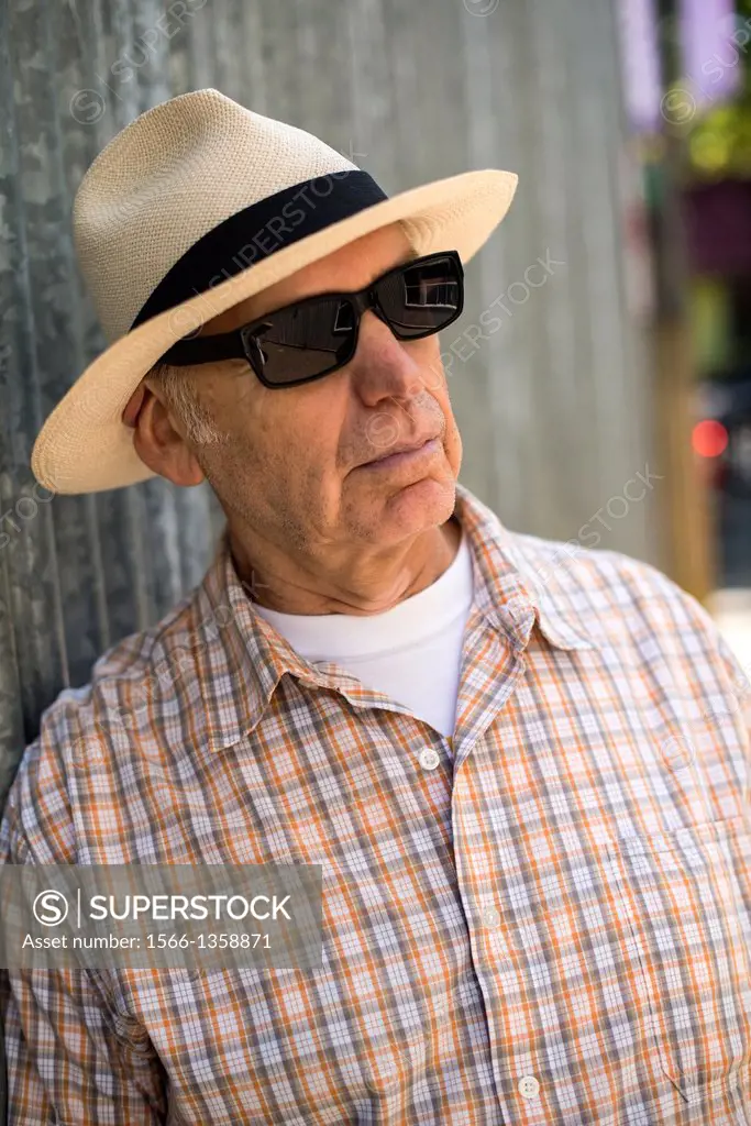man, 58, wearing a panama hat and sunglasses.
