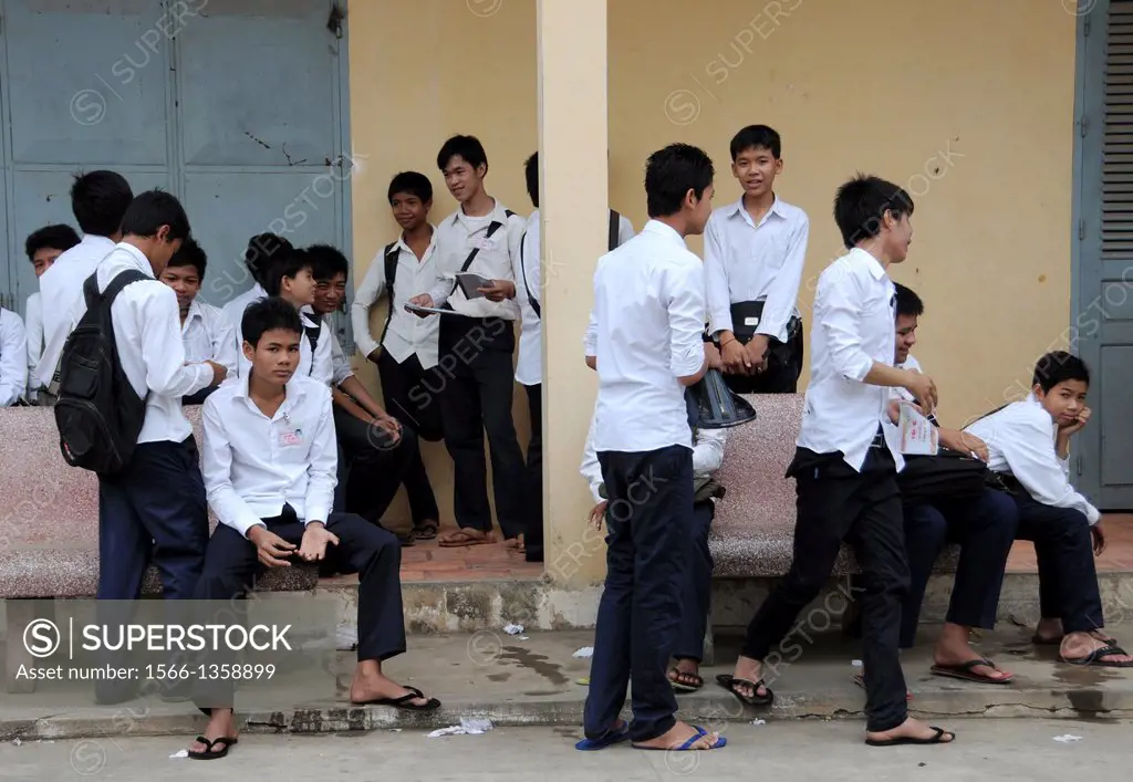 Male student in school uniform on the playground of a school in Battambang