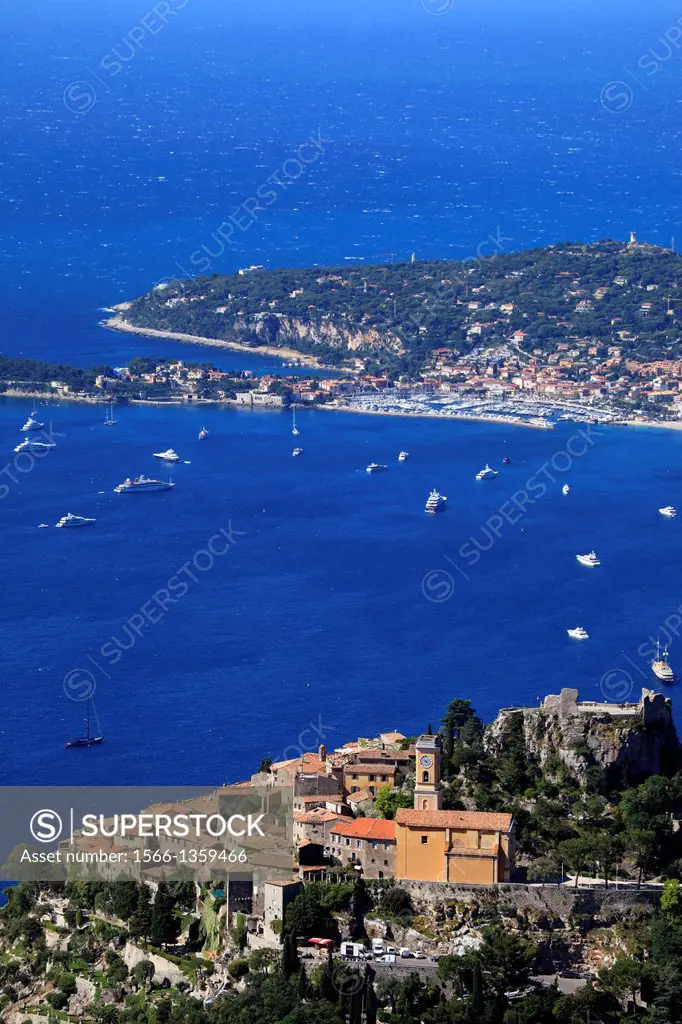 The medieval coastal perched village of Eze and the Cap Ferrat in the background, Alpes-Maritimes, French Riviera, Côte d'Azur, France.