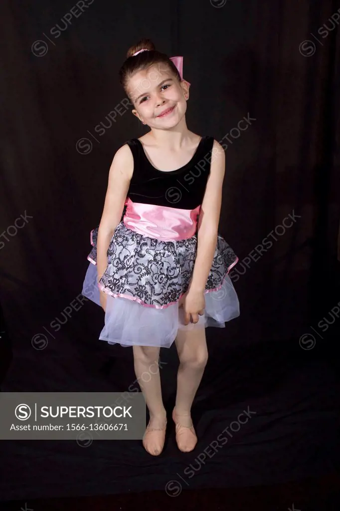 Little girl in her dancing outfits pose and have fun afront of the camera.
