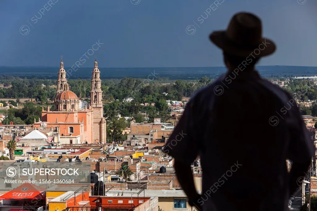 View from `El Calvario´. Man, in background Parroquia de la Asunción de María, Lagos de Moreno, Jalisco, Mexico.