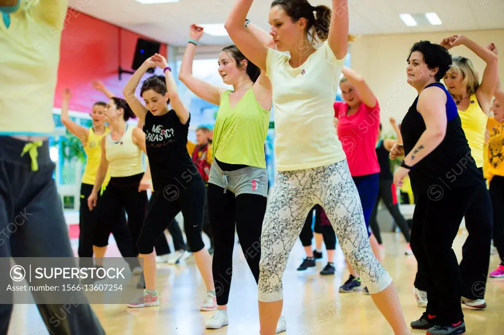 Women and girls taking part in a Zumba dance fitness exercise class UK.