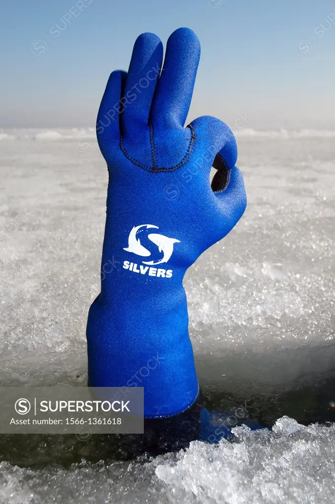 Diver's hand giving the Ok sign, subglacial diving, ice diving, in the frozen Black Sea, a rare phenomenon, last time it occured in 1977, Odessa, Ukra...