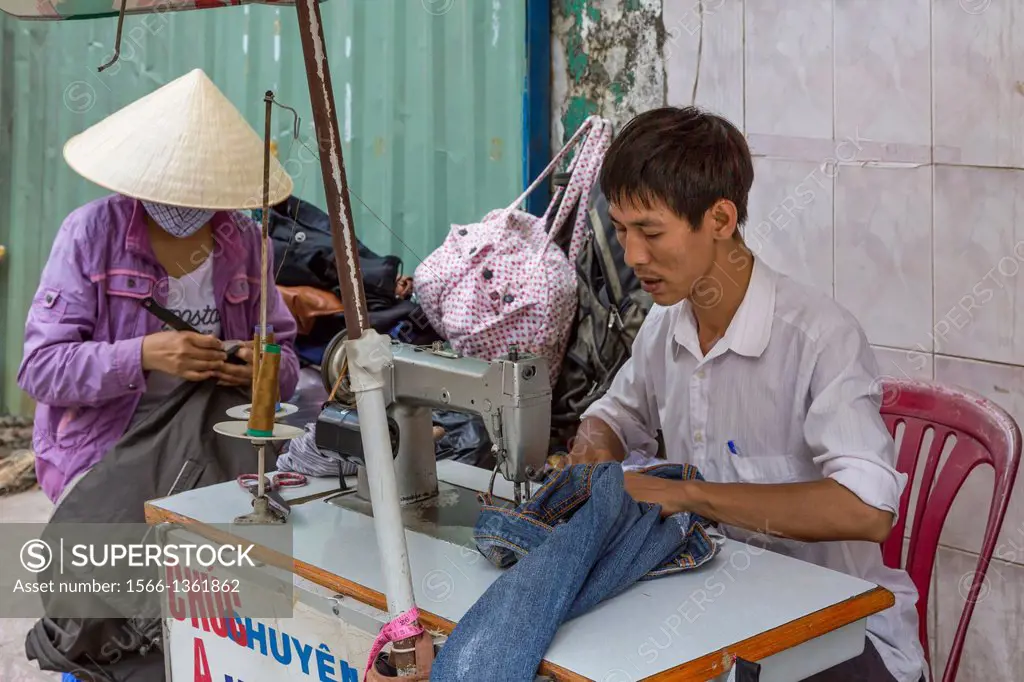 A streetside sewing shop in downtown Saigon, Ho Chi Minh City, Vietnam, Asia.
