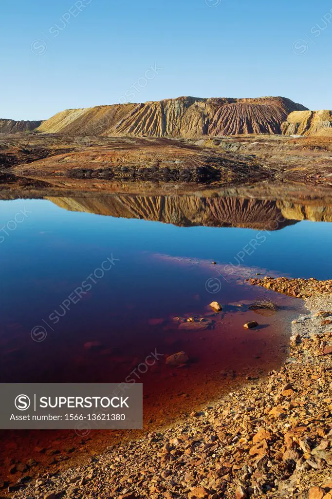 Dramatic landscape of mineral-rich ground and rock, scarred by the open-cast mineworkings of the Rio Tinto mines at the town of Minas de Riotinto and ...