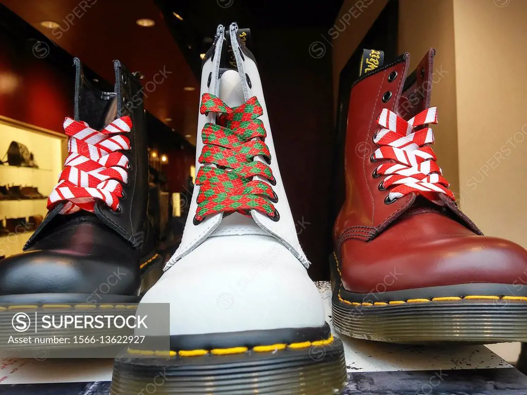 A display of Dr. Martens shoes showing their Christmas spirit in the window of a Dr. Martens store in New York