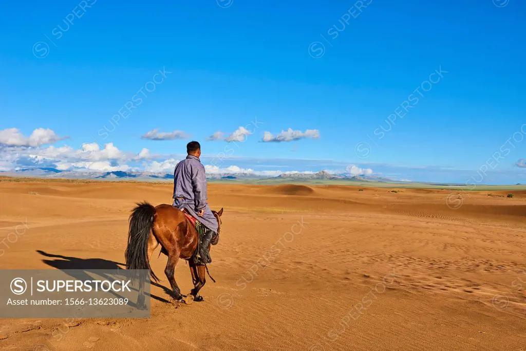 Mongolia, Zavkhan province, Mongolian horserider in the sand dunes.