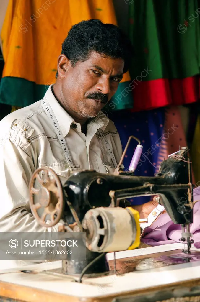 A tailor working on a sewing machine in Varkala, Kerala, South India.