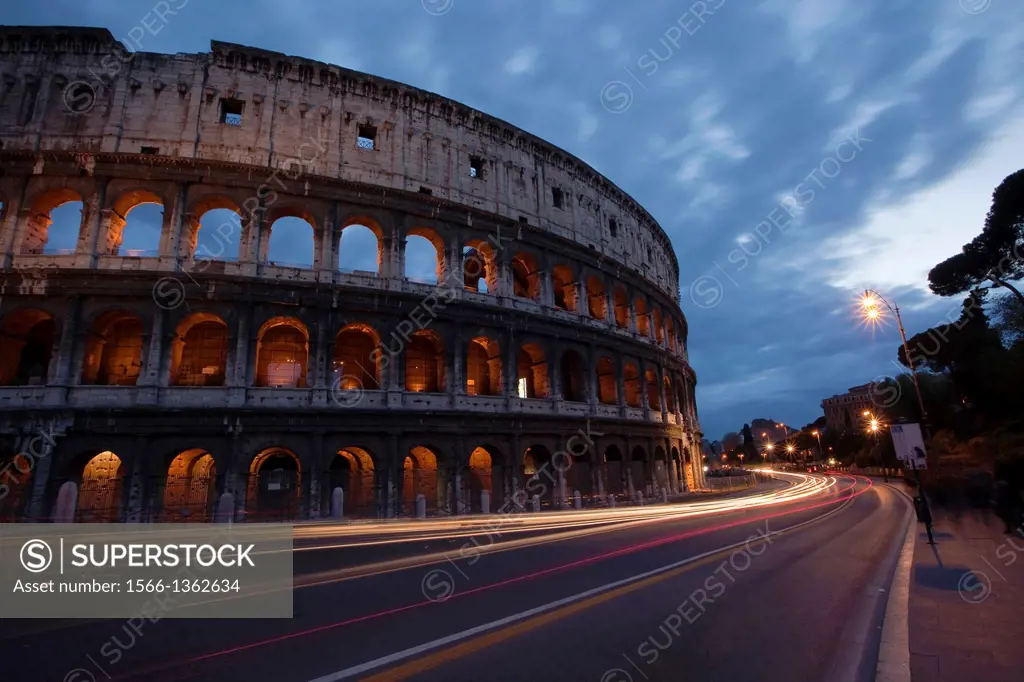 The Roman Colosseum and car light-trails, Rome, Lazio, Italy.