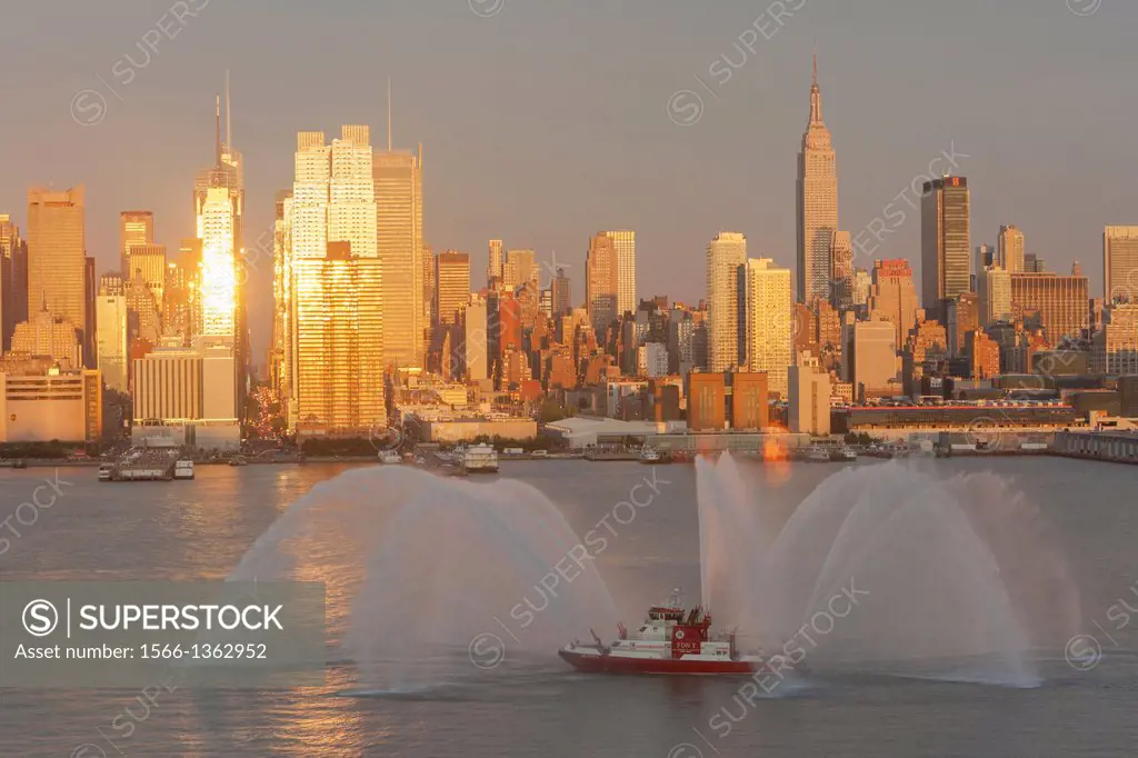 WEEHAWKEN, NJ - JULY 4: FDNY fire boat Marine 1 ""Three Forty Three"" puts on a water show on the Hudson river prior to the annual Macy's Fourth of Ju...