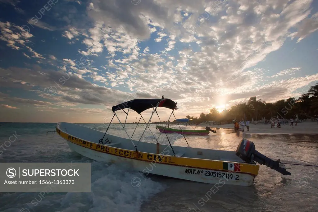 Fishing boats at sunset on Tulum public beach, Tulum, Quintana Roo, Yucatan Province, Mexico.
