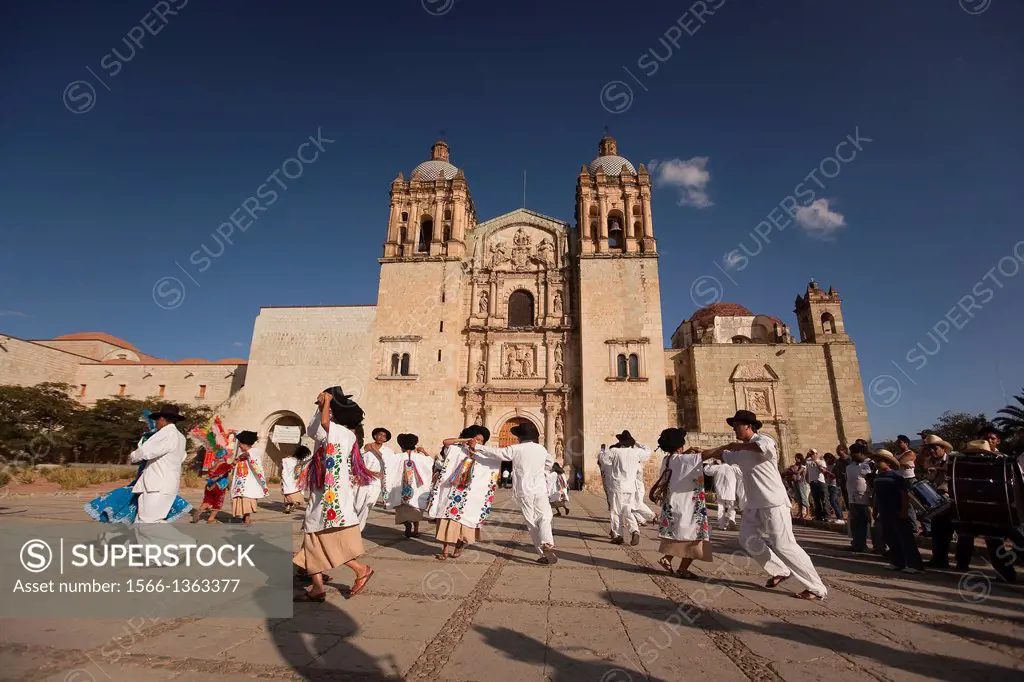 Dancers wearing traditional dresses performing in front of the Santo Domingo Church, Oaxaca, Mexico, North America.