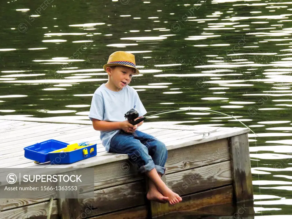 Young boy fishing off dock