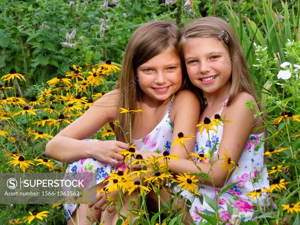 Fraternal twins in garden of flowers