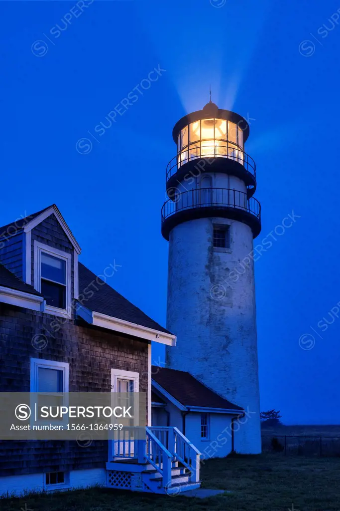 Ligthouse casts guiding light into dark blue night, Truro, Cape Cod, Massachusetts, USA.