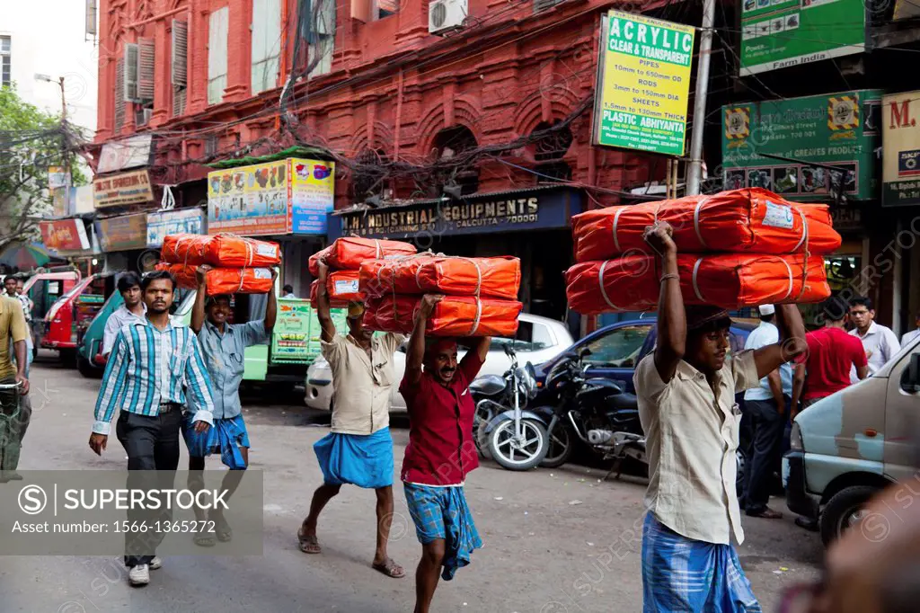 Man carrying Goods on his Head in Kolkata, India.