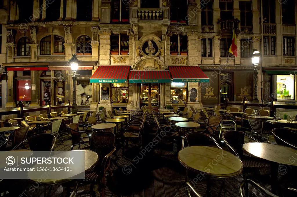 Empty tables at night in a restaurant on Grand Place in Brussels.
