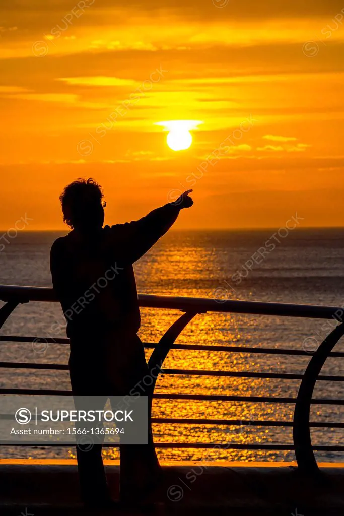 man with arm in the air,sunset, north pier, blackpool, lancs,england,uk.