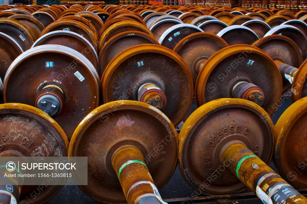 Railroad train wheel and axle assemblies at manufacturing plant, Tacoma, Washington USA.