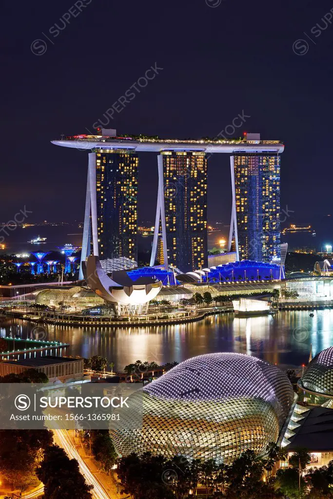 Aerial view of Marina Bay at night. In foreground The Esplanade theatre while in the background the tall towers of Marina Bay Sands. Singapore.