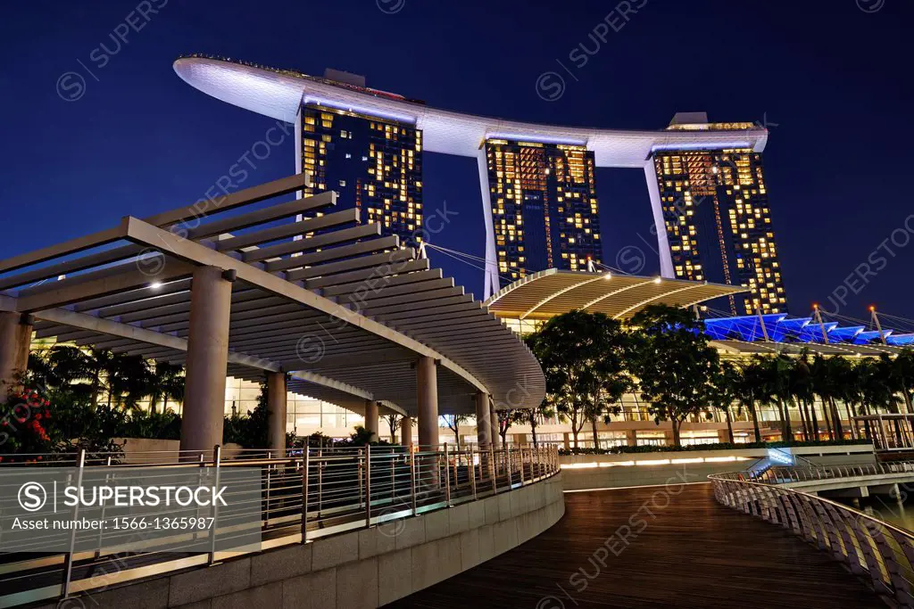 A walkway in marina Bay. On the background the three tall towers of Marina Bay Sands Hotel. Singapore.
