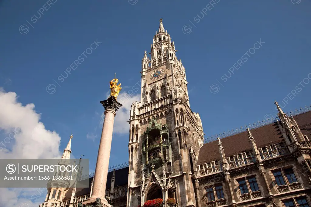 Virgin Mary atop the Mariensaeule and the new townhall Neues Rathaus on the central square Marienplatz in Munich, Bavaria, Germany.