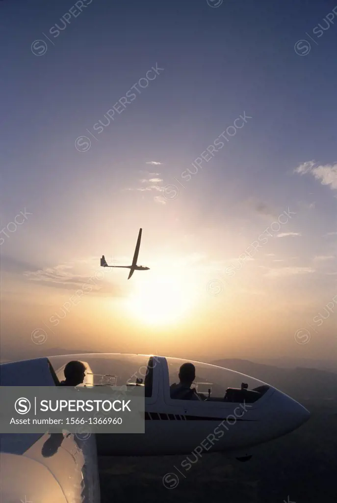 Glider planes Twin Astir and ASH-25 flying on sunset near Santa Cilia de Jaca, Aragon, Spain.