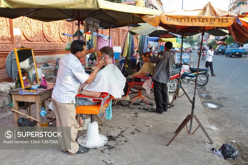 Hairdressing in the Streets of Phnom Penh, Cambodia.