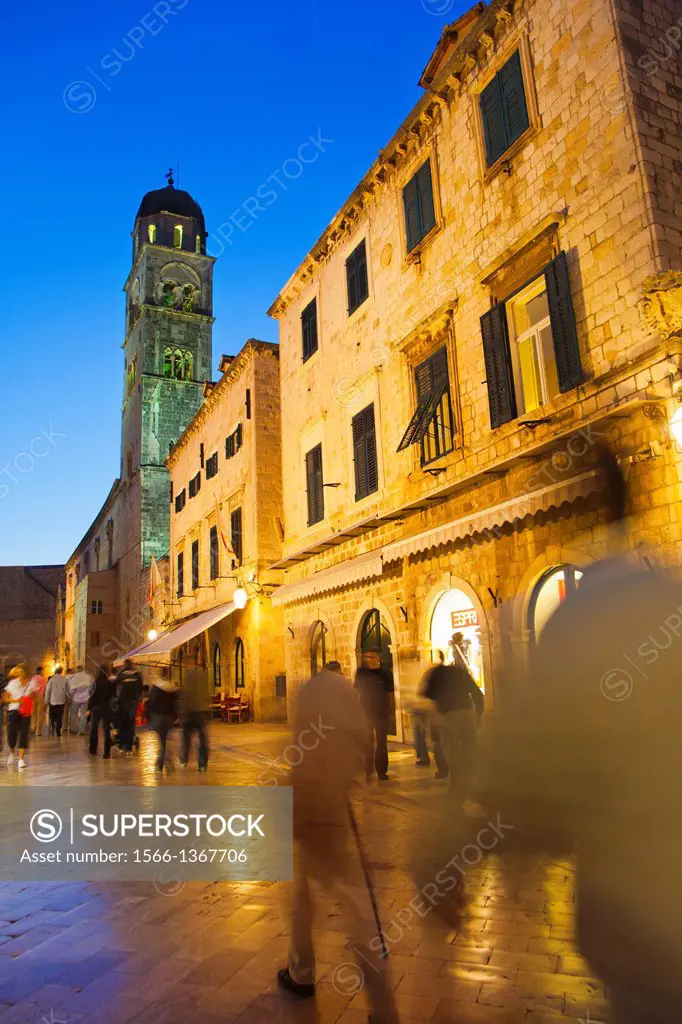 Looking West down the Stradun square towards pile gate and the Franciscan bell tower at night with shiny marble street surface, old town Dubrovnik. Cr...