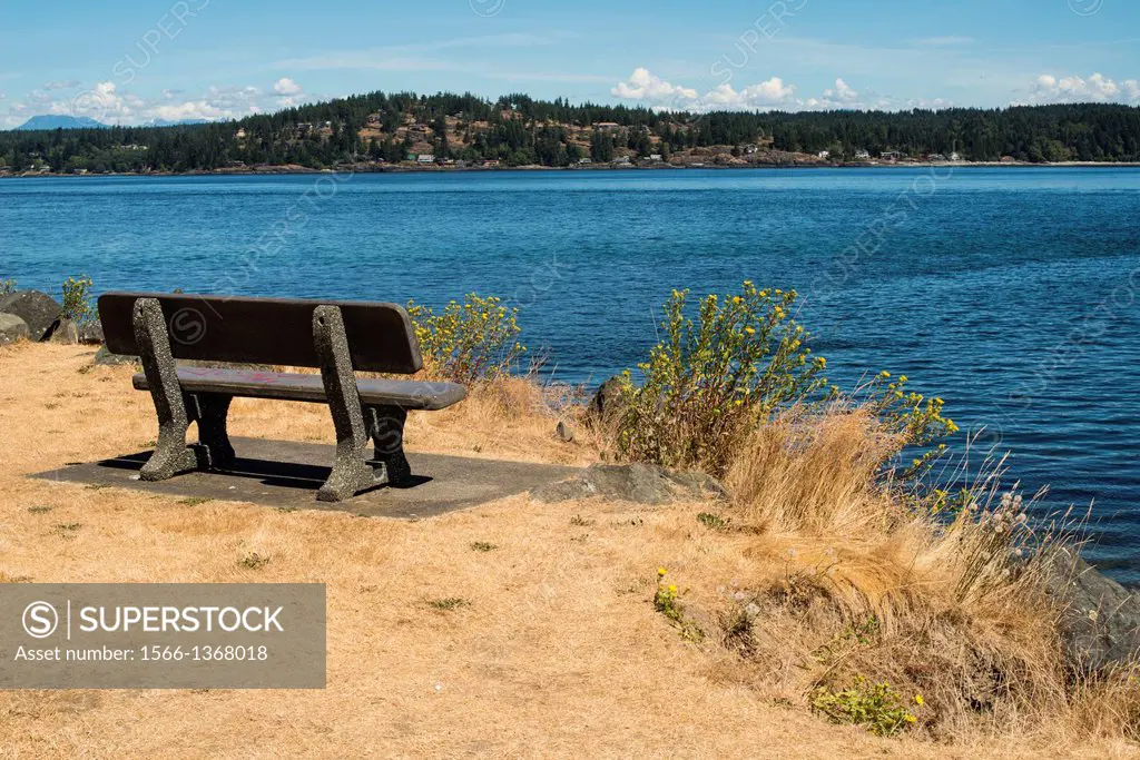 a bench in Robert V. Ostler Park in Campbell River, BC, Canada with a view toward Quadra Island