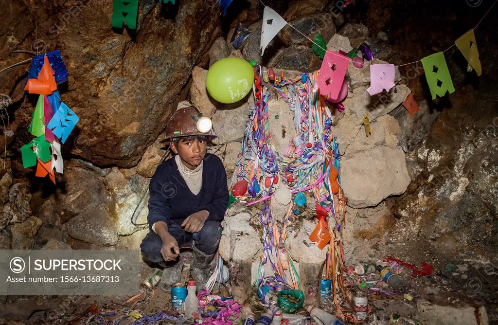 Samuel Castro Cruz and Tio (the demon protector of miners). 12 year old. Miner, Potosi, Bolivia.